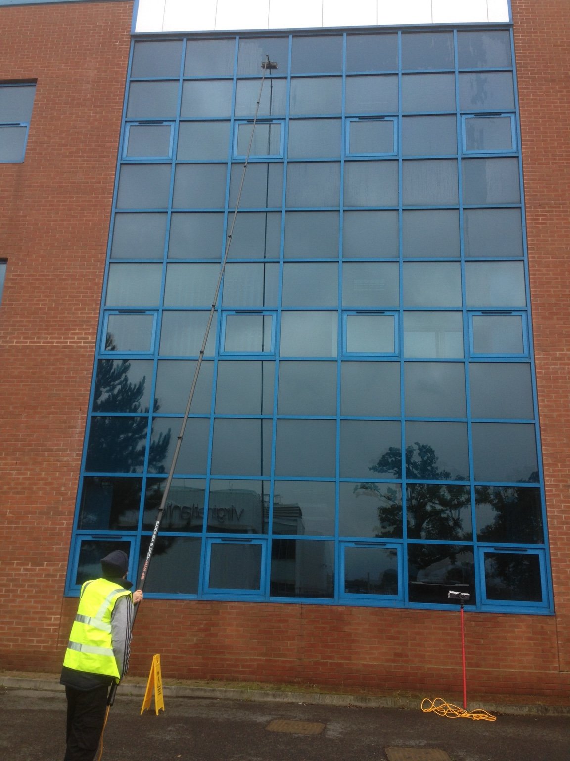 Commercial window cleaning with water-fed pole